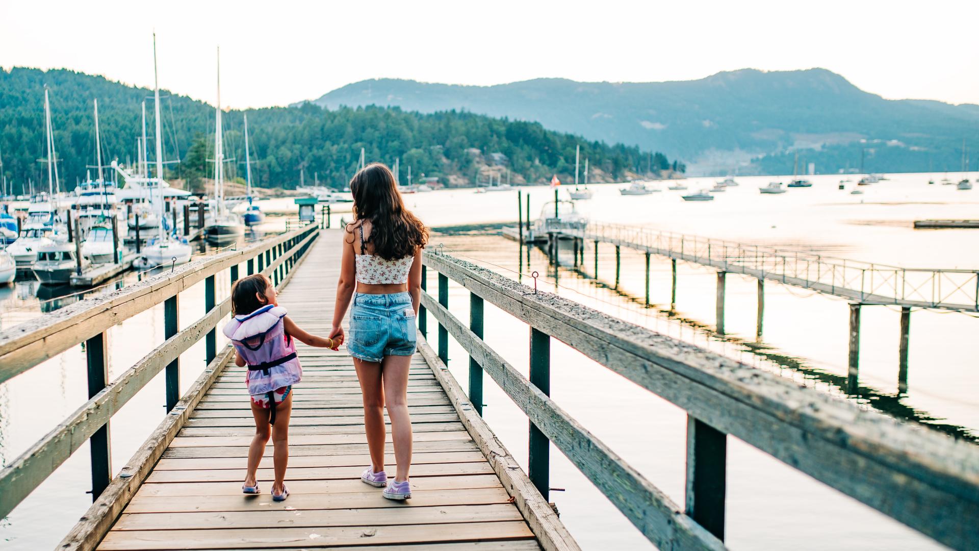 community brentwood bay children walking on a dock holding hands