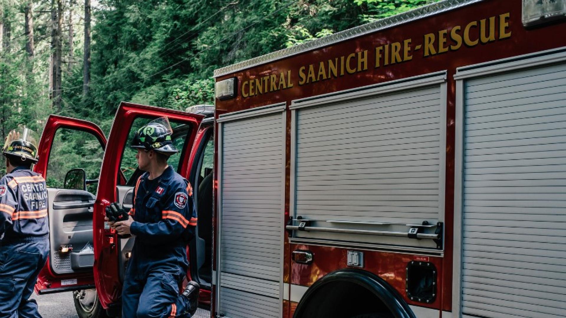 Two firefighters responding to a call from a Central Saanich Fire Rescue truck