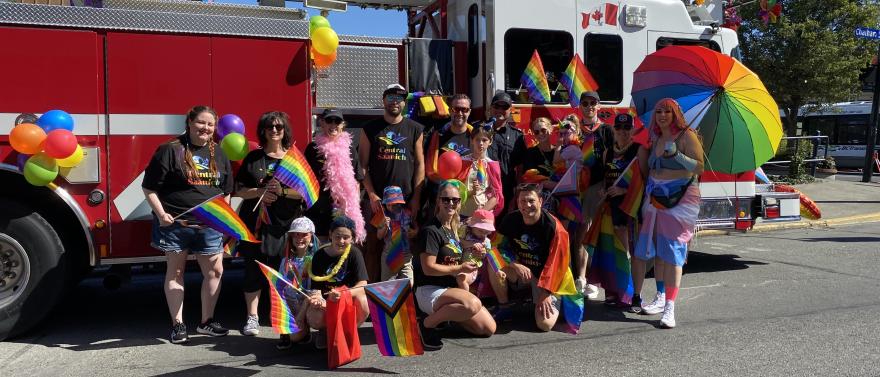 Pride parade group in front of fire truck