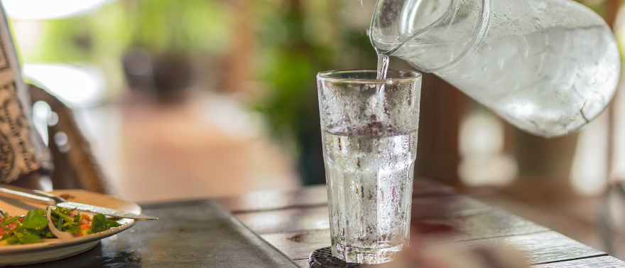 Person pouring glass of water