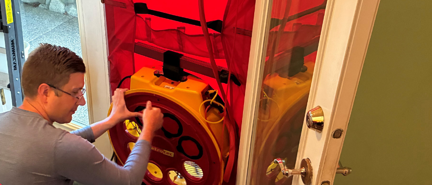 Energy Advisor conducting a blower door test